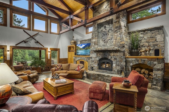 6286 Five Mile Rd, The Dalles, OR 98058 - living area with a stone fireplace, high vaulted ceiling, a wood ceiling with exposed beams, healthy amount of natural light, and wainscoting