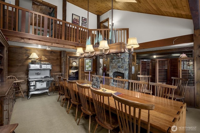 6286 Five Mile Rd, The Dalles, OR 98058 - dining space featuring high vaulted ceiling, carpet floors, wooden walls, wood ceiling, and a fireplace