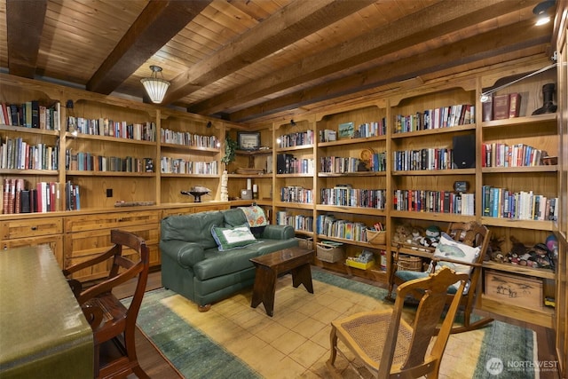 6286 Five Mile Rd, The Dalles, OR 98058 - living area featuring a wood ceiling with exposed beams, wall of books, and wood finished floors