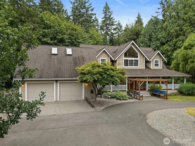 8495 Landing Ln SE, Port Orchard, WA 98367 - view of front of house with asphalt driveway, roof with shingles, and covered porch