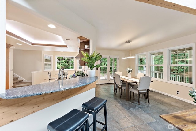 8495 Landing Ln SE, Port Orchard, WA 98367 - kitchen with stone countertops, a tray ceiling, hanging light fixtures, and french doors
