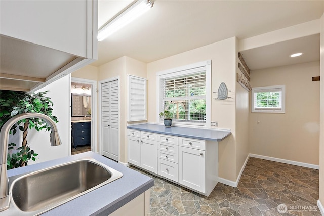 8495 Landing Ln SE, Port Orchard, WA 98367 - kitchen with stone finish floors and white cabinets