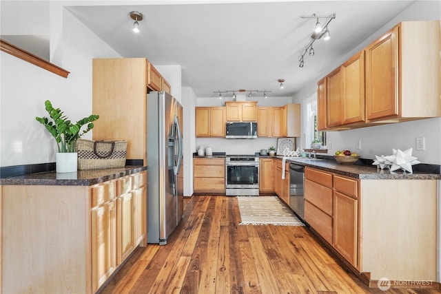 1910 192nd Avenue Ct SW, Lakebay, WA 98349 - kitchen with appliances with stainless steel finishes, hardwood / wood-style floors, dark countertops, track lighting, and light brown cabinetry