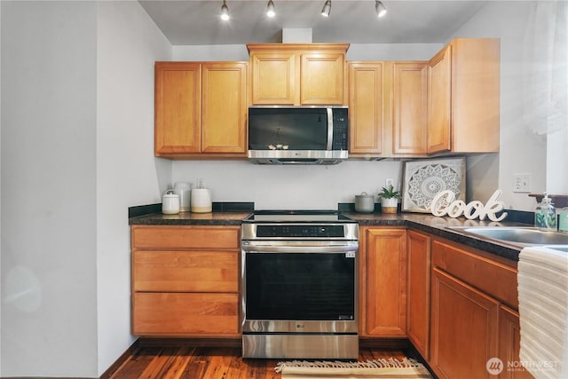 1910 192nd Avenue Ct SW, Lakebay, WA 98349 - kitchen with stainless steel appliances, dark countertops, dark wood-style floors, and track lighting