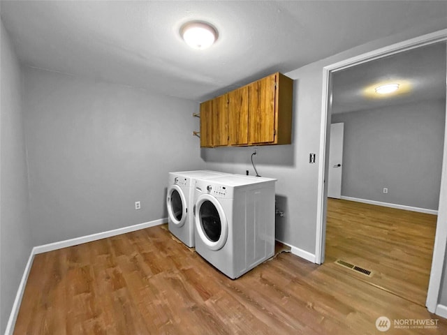 15518SE 304th Pl, Kent, WA 98042 - washroom with cabinet space, independent washer and dryer, and light wood-style floors