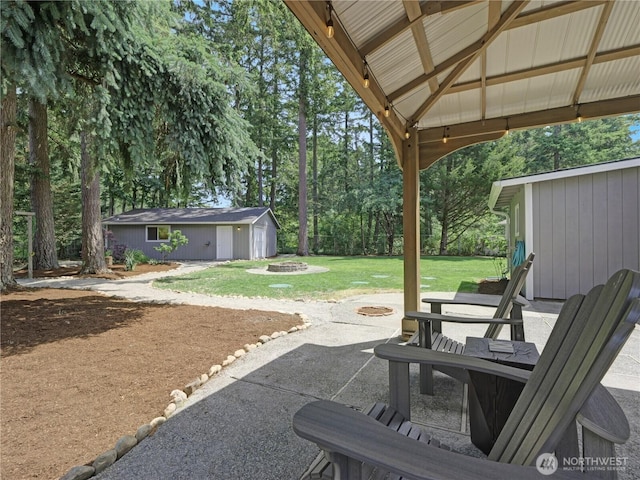 15518SE 304th Pl, Kent, WA 98042 - view of patio / terrace featuring a fire pit, an outbuilding, and view of scattered trees