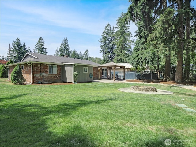 15518SE 304th Pl, Kent, WA 98042 - rear view of house with a patio, a gazebo, brick siding, and a fire pit