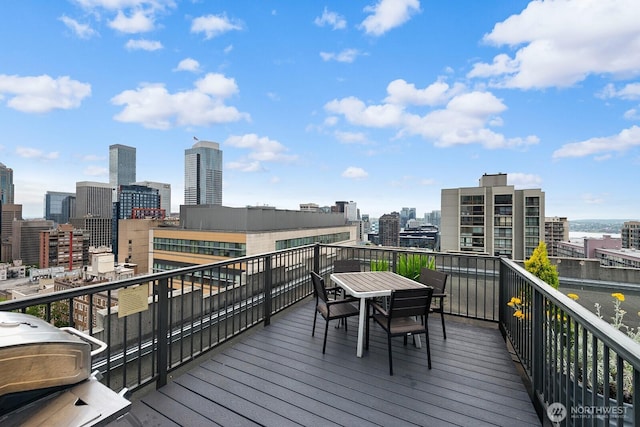 1105 Spring St Unit 407, Seattle, WA 98104 - wooden terrace with a skyline view, area for grilling, and outdoor dining area