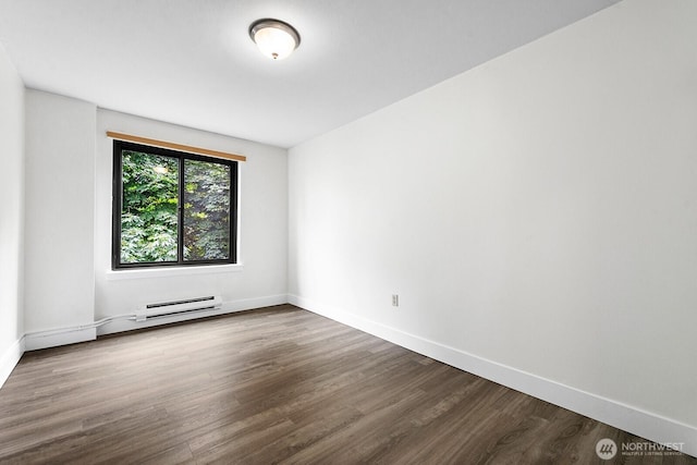 1105 Spring St Unit 407, Seattle, WA 98104 - unfurnished room with a baseboard heating unit and wood finished floors