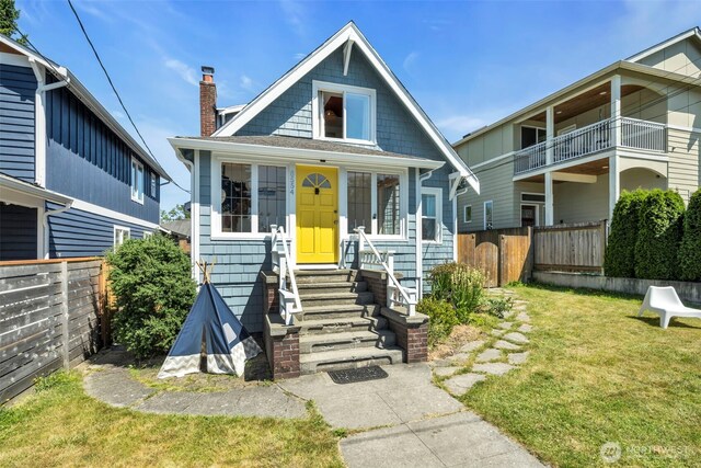 8554 16th Ave NW, Seattle, WA 98117 - view of front facade featuring a fenced backyard, entry steps, and a chimney