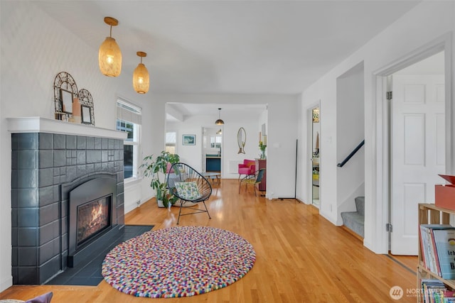 8554 16th Ave NW, Seattle, WA 98117 - living room featuring wood finished floors, a fireplace with flush hearth, and stairway