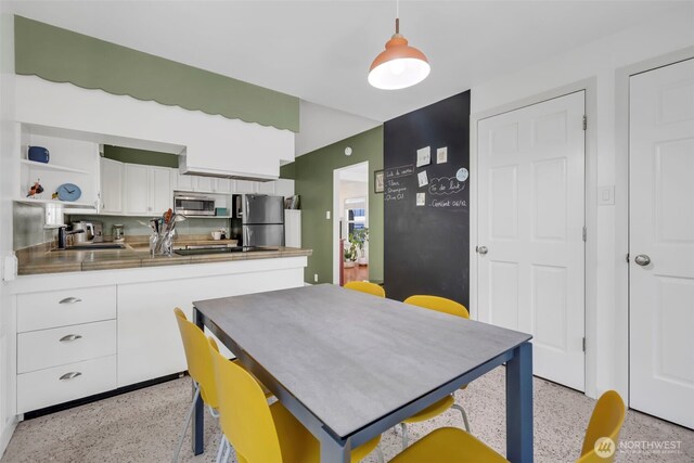 8554 16th Ave NW, Seattle, WA 98117 - dining room with dark aggregate flooring