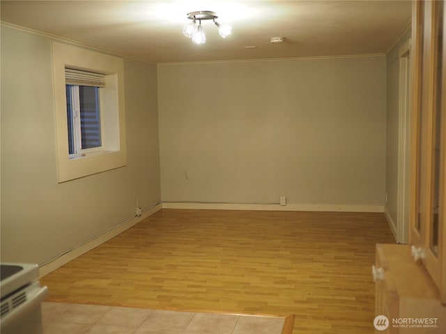 8554 16th Ave NW, Seattle, WA 98117 - empty room featuring ornamental molding, light wood finished floors, and a smoke detector