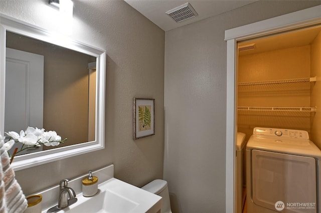 3030 128th Ave SE Unit 6, Bellevue, WA 98005 - bathroom featuring washing machine and clothes dryer and a textured wall