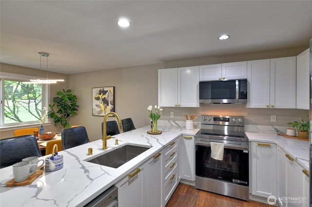 3030 128th Ave SE Unit 6, Bellevue, WA 98005 - kitchen with appliances with stainless steel finishes, white cabinets, dark wood-style floors, a peninsula, and recessed lighting