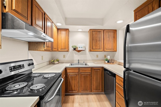 140 Summit Ave N Unit A6, Kent, WA 98030 - kitchen with appliances with stainless steel finishes, exhaust hood, brown cabinets, light wood-type flooring, and light countertops