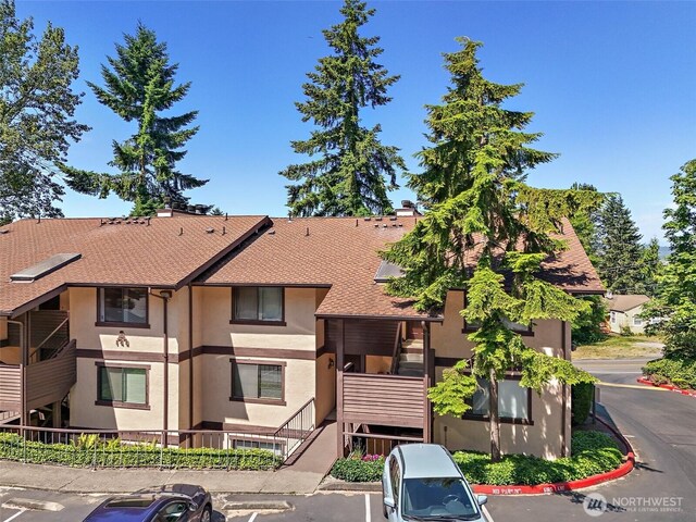140 Summit Ave N Unit A6, Kent, WA 98030 - view of front of home with uncovered parking, stucco siding, and roof with shingles