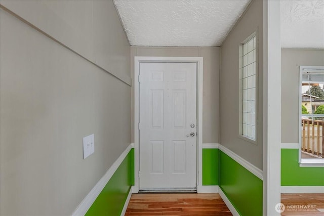 3001 S 288th Unit 89, Federal Way, WA 98003 - doorway to outside with a textured ceiling, wood finished floors, and baseboards
