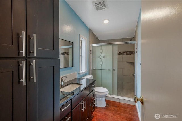 3001 S 288th Unit 89, Federal Way, WA 98003 - bathroom featuring toilet, wood finished floors, a shower stall, and vanity