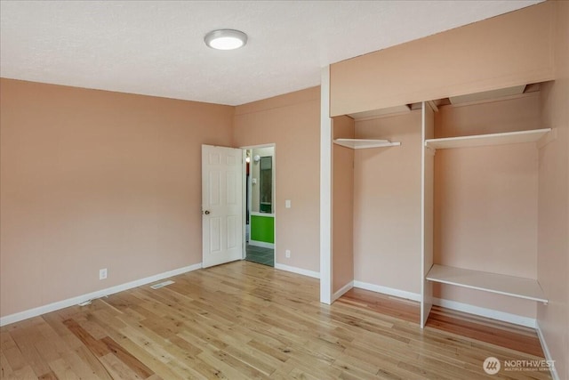 3001 S 288th Unit 89, Federal Way, WA 98003 - unfurnished bedroom featuring wood finished floors, a closet, and baseboards