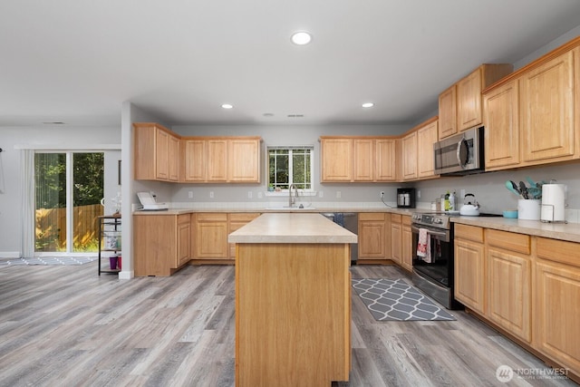 17814 97th Ln E, Puyallup, WA 98375 - kitchen featuring stainless steel appliances, light brown cabinetry, light countertops, light wood-style flooring, and a kitchen island