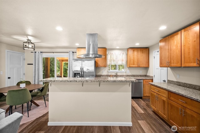7514 Greenridge St SW, Olympia, WA 98512 - kitchen featuring appliances with stainless steel finishes, island range hood, a sink, dark wood-type flooring, and a kitchen island