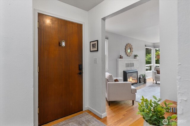 3604 SW Graham St, Seattle, WA 98126 - entryway with light wood finished floors and a brick fireplace
