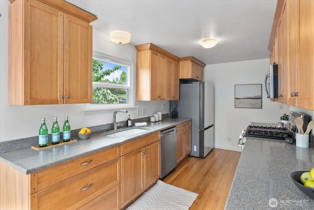 3604 SW Graham St, Seattle, WA 98126 - kitchen featuring stainless steel appliances, light wood-type flooring, and light stone countertops