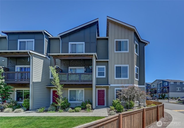 17401 118th Avenue Ct E Unit A, Puyallup, WA 98374 - view of front of house with board and batten siding, a balcony, and a residential view