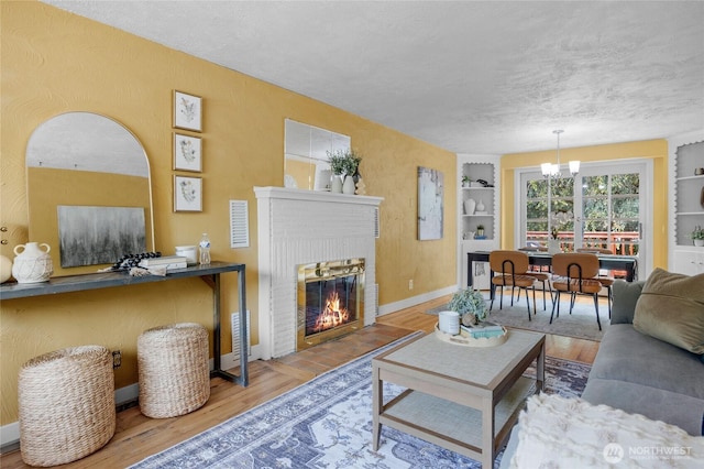 13743 36th Ave NE, Seattle, WA 98125 - living area featuring built in shelves, wood finished floors, and a textured ceiling