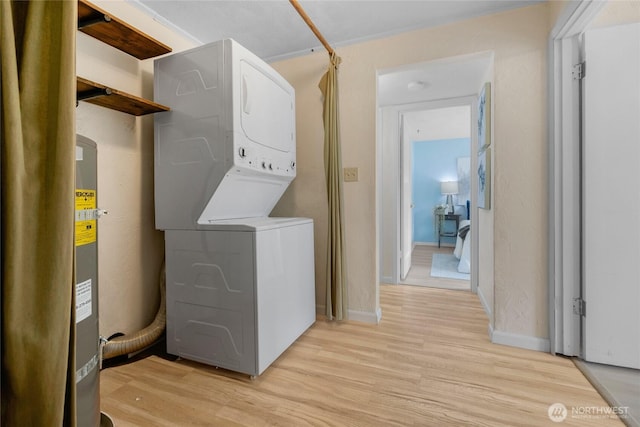 13743 36th Ave NE, Seattle, WA 98125 - laundry room with stacked washing machine and dryer and light wood-type flooring