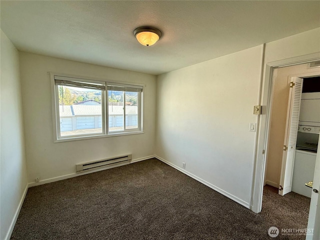 155 Lavender Ct Unit 47, Wenatchee, WA 98801 - unfurnished room with a baseboard heating unit, dark carpet, and baseboards