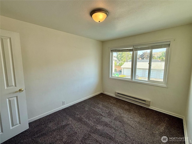 155 Lavender Ct Unit 47, Wenatchee, WA 98801 - unfurnished room with a baseboard heating unit, dark carpet, and baseboards