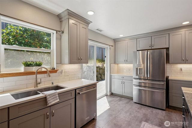 29664 127th Pl SE, Auburn, WA 98092 - kitchen with appliances with stainless steel finishes, gray cabinetry, healthy amount of natural light, tasteful backsplash, and recessed lighting