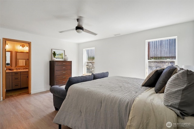 29664 127th Pl SE, Auburn, WA 98092 - bedroom with light wood-style flooring, connected bathroom, and ceiling fan