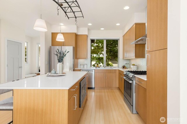 5175 42nd Ave S, Seattle, WA 98118 - kitchen with stainless steel appliances, light wood-type flooring, light countertops, recessed lighting, and tasteful backsplash