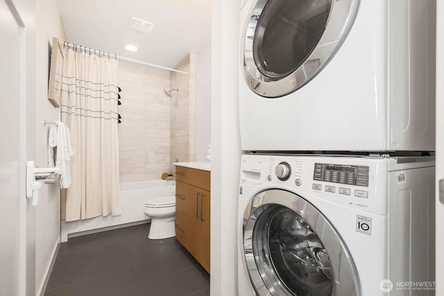 5175 42nd Ave S, Seattle, WA 98118 - washroom with estacked washer and dryer, dark tile patterned floors, and recessed lighting