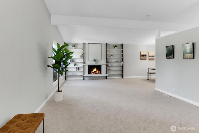 12427 NE 141st Way, Kirkland, WA 98034 - unfurnished living room with carpet, a warm lit fireplace, and vaulted ceiling