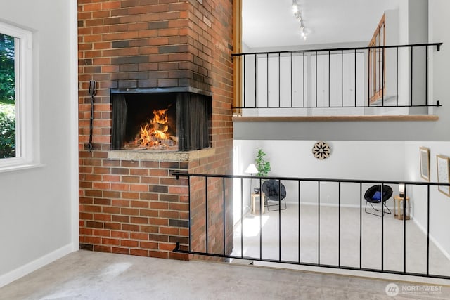 12427 NE 141st Way, Kirkland, WA 98034 - detailed view of concrete flooring, a brick fireplace, and rail lighting