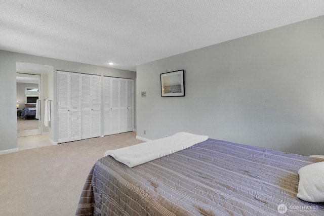 12427 NE 141st Way, Kirkland, WA 98034 - carpeted bedroom featuring two closets and recessed lighting