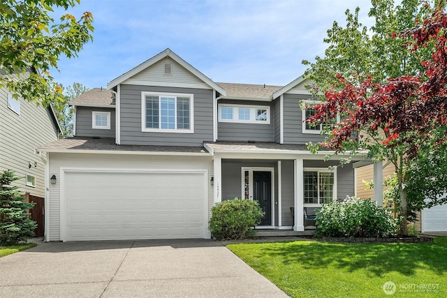 15527 E 82nd Ave E, Puyallup, WA 98375 - view of front of house with driveway, a shingled roof, an attached garage, a porch, and a front lawn
