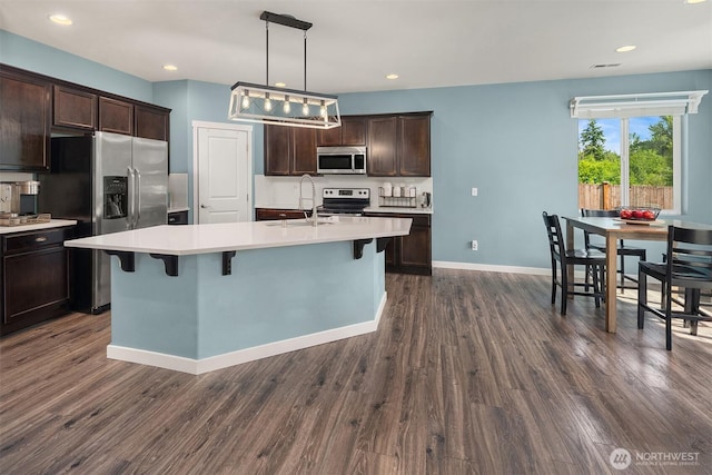 15527 E 82nd Ave E, Puyallup, WA 98375 - kitchen with appliances with stainless steel finishes, dark brown cabinetry, light countertops, dark wood-style floors, and recessed lighting