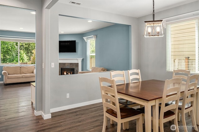 15527 E 82nd Ave E, Puyallup, WA 98375 - dining room with dark wood-type flooring, a fireplace, a chandelier, and recessed lighting