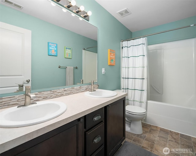 15527 E 82nd Ave E, Puyallup, WA 98375 - bathroom with double vanity, shower / bath combo, and stone finish flooring