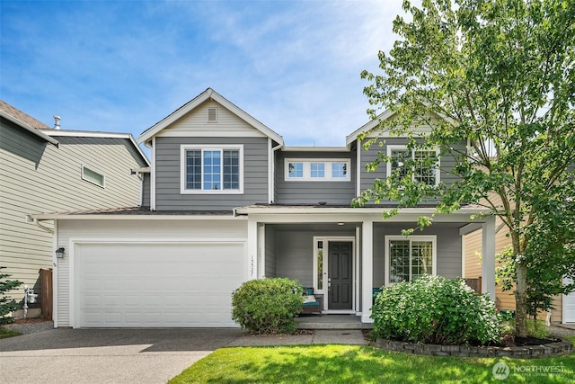 15527 E 82nd Ave E, Puyallup, WA 98375 - view of front of home with concrete driveway, an attached garage, and covered porch