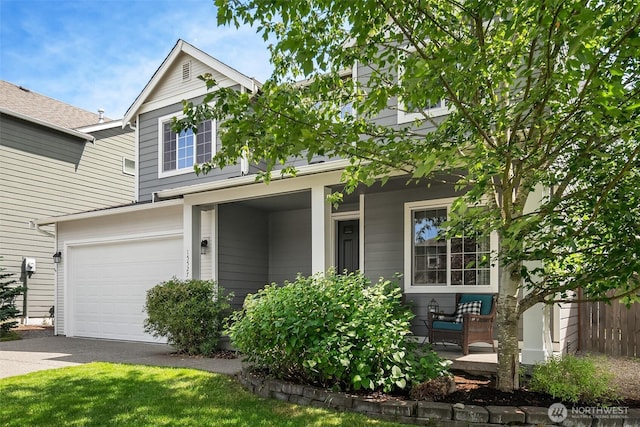 15527 E 82nd Ave E, Puyallup, WA 98375 - view of front of house featuring an attached garage, covered porch, and driveway
