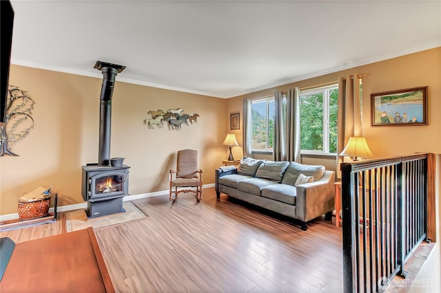 221 S Prairie Carbon River Rd E, South Prairie, WA 98385 - living area featuring light wood-type flooring, a wood stove, and crown molding