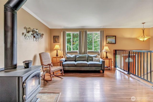 221 S Prairie Carbon River Rd E, South Prairie, WA 98385 - living room featuring a wood stove, wood finished floors, and crown molding