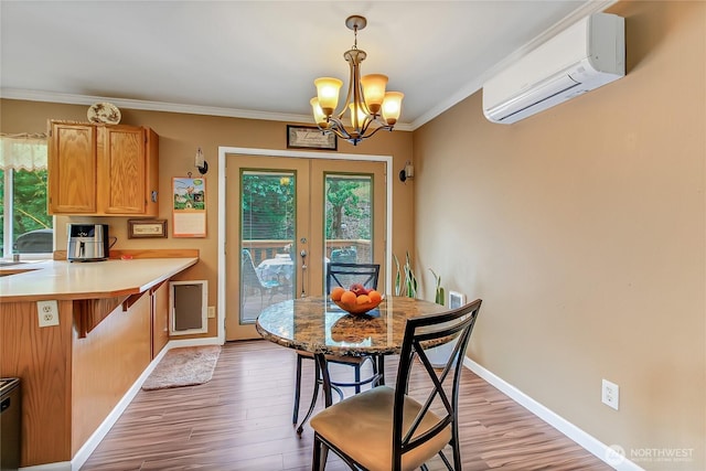 221 S Prairie Carbon River Rd E, South Prairie, WA 98385 - dining room with an AC wall unit, a chandelier, light wood-style floors, crown molding, and french doors
