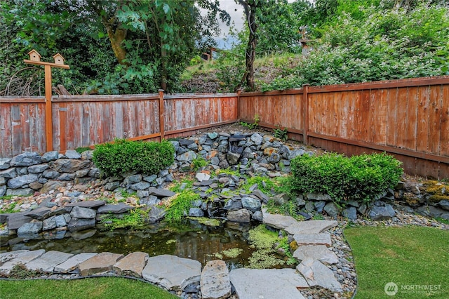 221 S Prairie Carbon River Rd E, South Prairie, WA 98385 - fenced backyard featuring a garden pond